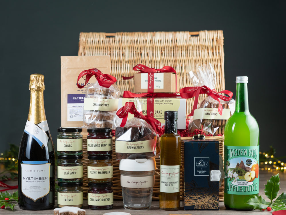 Wicker Hamper filled with Christmas herbs and spice, chutney, jam, marmalade, cooking oil, Salcombe dairy chocolate library, ginger thins, cinnamon stars, brownie pieces, Christmas cake and pudding, Ridgden apple juice, Nyetimber classic cube or Wiston Brut, Union coffee, HG KeepCup