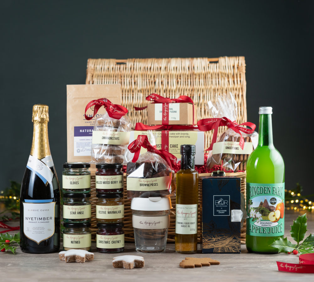 Wicker Hamper filled with Christmas herbs and spice, chutney, jam, marmalade, cooking oil, Salcombe dairy chocolate library, ginger thins, cinnamon stars, brownie pieces, Christmas cake and pudding, Ridgden apple juice, Nyetimber classic cube or Wiston Brut, Union coffee, HG KeepCup