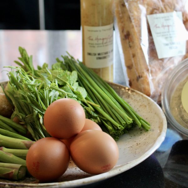 Image of Eggs, green beans and herbs on a plate. The Hungry Guest Focaccia and mustards dressing on the side