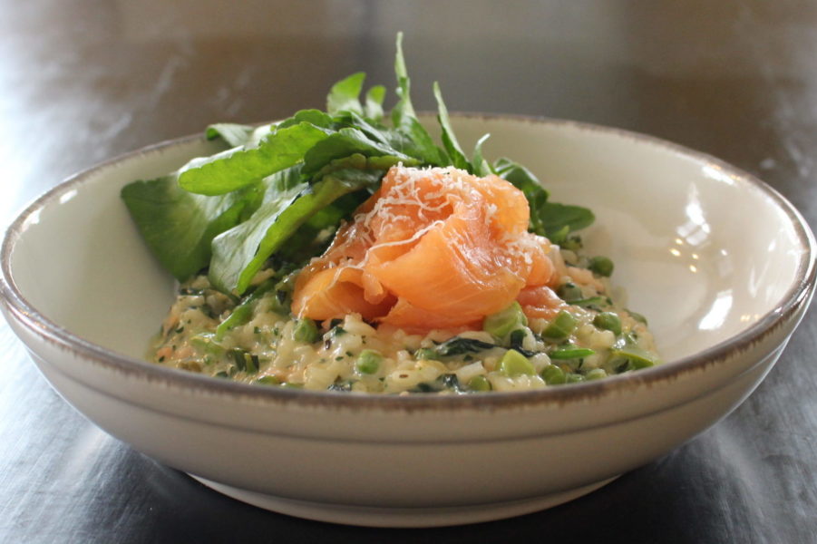 Bowl of the wild garlic and spring green risotto with smoked salmon
